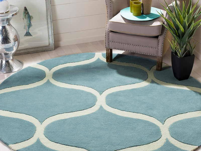 Round hand tufted carpet placed under a centre table